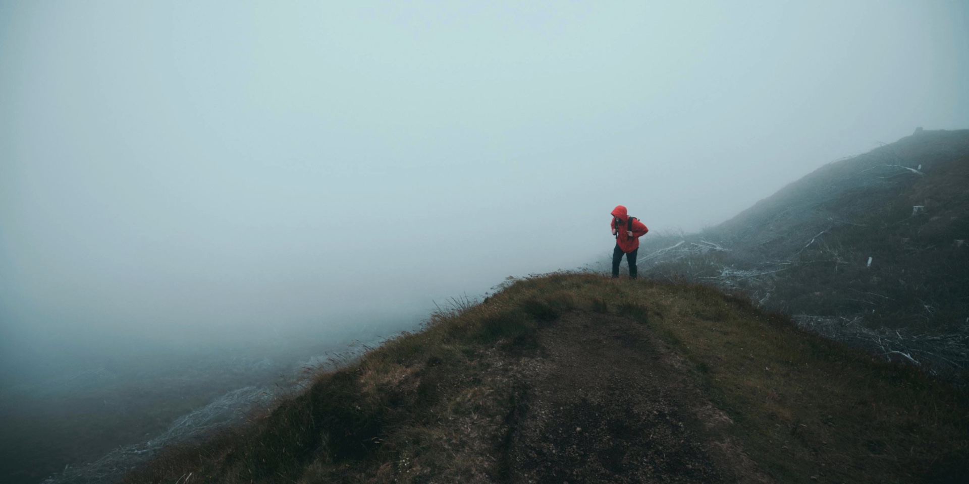 Hiker on misty trail